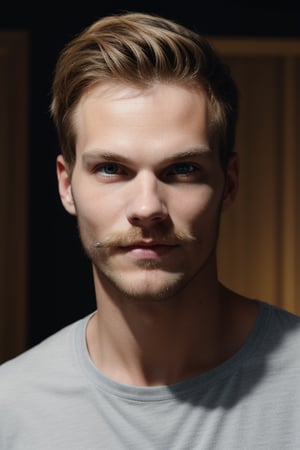 A medium-shot captures the American man, a doppelganger of Avicii, with a warm and inviting expression. Caramel blonde hair is messy and textured, framing his angular face with light blue eyes that seem to sparkle under natural lighting. A sparse moustache and beard add a rugged touch to his features. He wears a navy blue t-shirt that complements the cool tone of his eyes, as he stands confidently in a well-lit room with a subtle background noise.