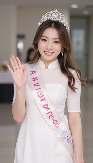 a young beautiful asian woman wearing a white vietnamese aodai and a crown, smilling, hand waving, wearing a sash writing "MISS VIETNAM"