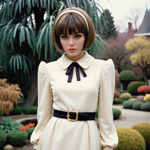 spoiled entitled woman with short bobbed hair with short straight severe bangs 1970's double knit polyester long sleeved princess dress belted with huge poofy shoulders with very wide and very large shoulder pads with a huge collar, with a fancy blouse tie in a weird abstract sculpture garden,cinematic style