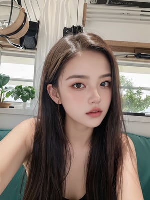 a selfie of a young girl sitting indoors. She has long brown hair and appears to be in a casual setting. She's making a slight pout with her lips, and her expression is playful and relaxed. The lighting in the area is bright, interior space