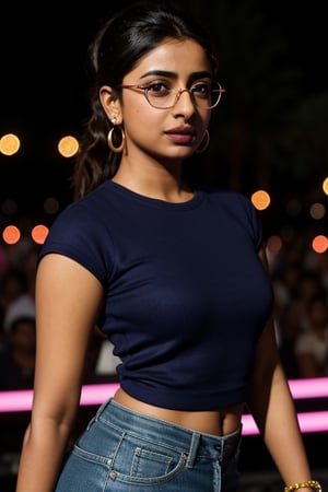 full format photo-realistic wide shot image of a Pakistani woman, Radhika Apte, Priyanka Chopra Jonas, short ponytail, wearing glasses, wearing a navy blue ribbed T-shirt that is tight-fitting, standing in the middle of a dance circle, Coachella concert, confident hype expression, a curvy figure, small waist, big nose,

candid photo, full body shot, ((wide shot)), low angle shot, colorful party lights, night, 

small gold earrings, dark skin, nice skin, natural skin texture, highly detailed 8k skin texture, 

detailed face, detailed nose, realism, realistic, raw, photorealistic, stunning realistic photograph, smooth, actress ,more detail , 