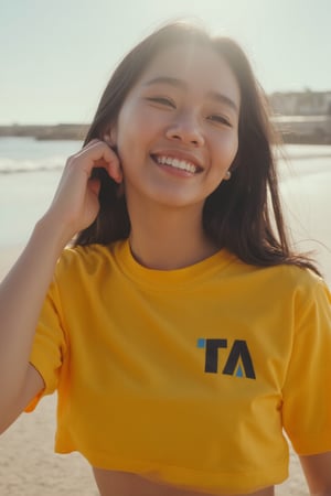 medium shot of japanese woman wearing a yellow crop top with black, ta_logo  at beach, cinematic shot, she is smiling happy while the sun is brimming on her face