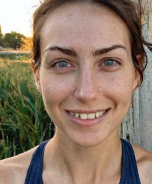 Raw photo portrait of a woman without makeup, sunny day, outdoors, smirk, detailed eyes, detailed pupils, natural skin, skin details, 30yo