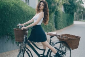 ((manara skirt)) raw photography, cinematic still, MGM, extremely beautiful xxmixgirl riding a bicycle