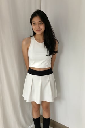 1girl, solo, long hair, looking at viewer, smile, skirt, shirt, black hair, bare shoulders, closed mouth, standing, white shirt, cowboy shot, sleeveless, indoors, black eyes, lips, head tilt, sleeveless shirt, arms behind back, white skirt, realistic, shirt tucked in, tight miniskirt, full_body, white shoes, white socks