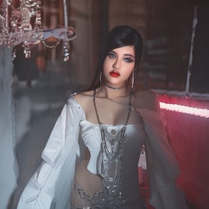 beautiful woman showing off her curves with a y2k ripped up outfit, dark jet black hair, wearing lots of diamond necklaces, lots of jewelry with crosses, long sharp nails, glossy black high heels, red lighting, foggy room