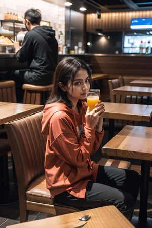 ultra realistic, natural face and body structure, full body shot, she is a beautiful 21 year old indian girl, clear forehead, shot from a distance, india background, looking aesthetic, she is in a restaurant with a lot of foods on the table and sipping juice with straw, night time,  she is wearing a loose and baggy trouser, wearing baggy hoodie,  there are many families in the restaurant 