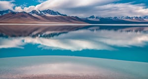 Masterpiece, highest quality, 8k high quality photo, perfect details, perfect composition, ultra high definition, sky over the Salt Lake of Uyuni, mirror-like surface of the lake, reflection in the water, majestic distant mountains, dark clouds, lightning