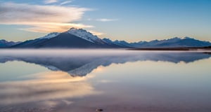 Masterpiece, highest quality, 8k high-quality photos, perfect details, perfect composition, ultra-high definition, the sky over the Salt Lake of Uyuni, the mirror-like surface of the lake, reflections in the water, majestic distant mountains, low mist,