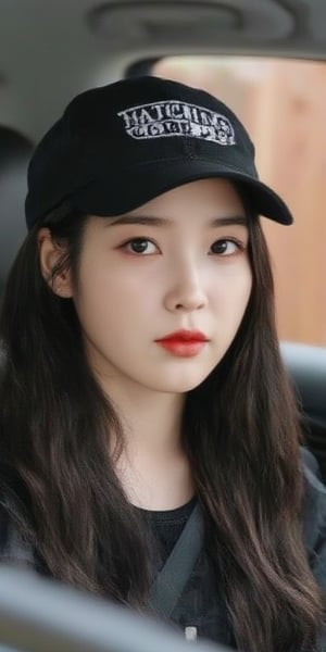 A close-up shot of a young Asian woman with long dark brown hair, wearing a black baseball cap with a white logo on the front that reads "MATCHING COUPLE" in white letters. She is sitting in the back of a black car seat, her hair cascades down to her shoulders. The background is blurred, with a wooden fence visible behind her.,Iu