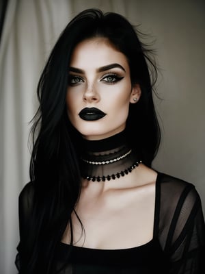 a person with a unique alternative aesthetic.   They have long, straight black hair.  The individual's eyes are a soft green and they wear spectacular black lipstick.   They have a septum piercing and several earrings in one ear.   Her makeup is highlighted by winged eyeliner, adding an edgy touch.   They wear a black t-shirt with a graphic design visible on the neckline and their look is complemented by a black choker and layered necklaces.   The background has a mottled or mottled texture in grayish tones, which complements the dark tones of her clothing and makeup.