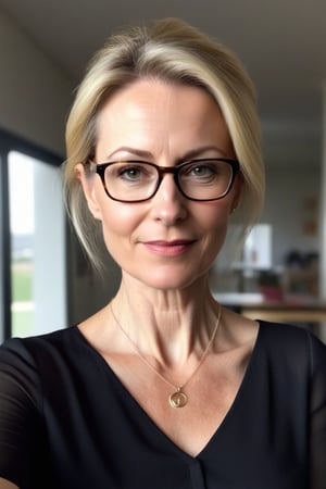 Create a selfie of a (((55-year-old European female teacher))) with pale skin, inperfect skin, small_breasts, tiny breasts; and a sleek slim silhouette. She has blonde hair with a small messy bun, long oval face with warm and friendly look, small thin lips, light makeup, wearing ((glasses)), (((tight sheer shirt with deep neckline, thin pendant necklace))), realisitic background, realistic indoor lightning of the face.