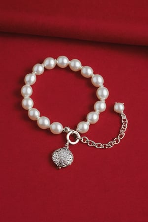 Photo of a pearl bracelet on a red bedclothes