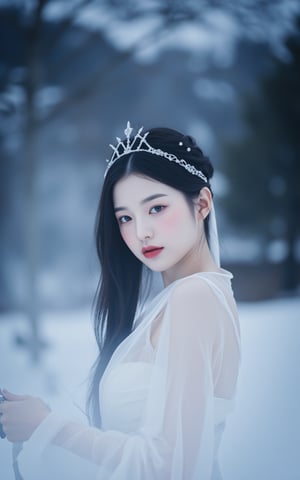 This is a high-resolution photograph of a young East Asian woman with a delicate, ethereal appearance. She is captured in a dramatic, otherworldly setting, with a snowy, misty background and a soft, diffused light. The woman has long, straight black hair cascading down her back, adorned with a delicate, silver hairpiece that resembles a crown. Her facial features are delicate and her skin is pale, with a slight pink undertone. She has a small, delicate nose, full lips painted in a vibrant red, and her eyes are almond-shaped with a soft, dreamy gaze. She is dressed in a flowing, white, semi-transparent robe, which appears to be made of sheer, gossamer fabric, giving it a misty, ghostly quality. She holds a sword in her right hand, poised as if in a defensive or dramatic stance. The sword is slender and elegant, with a delicate blade. 