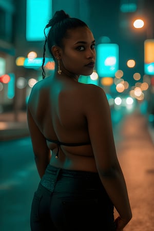 A stylish brown-skinned woman stands out against the sleek, teal-hued cityscape in a Matrix-inspired scene. The warm glow of streetlights and neon signs casts an orange filter over her, creating a striking contrast with the cool urban backdrop. She exudes confidence as she gazes out into the distance, her pose a fusion of strength and sophistication.,Transgender mallu