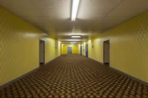 Masterpiece-quality, 4K RAW image of a photorealistic HDR scene. In a dimly lit, level-0 tutorial room, fluorescent lights hum above, casting an eerie glow on patterned walls and long corridors that seem to stretch into infinity. Yellow-walled backrooms create a liminal space, where carpeted floors whisper secrets beneath the hum of machinery. Capture the essence of this sterile environment with precise detail and photorealistic accuracy.