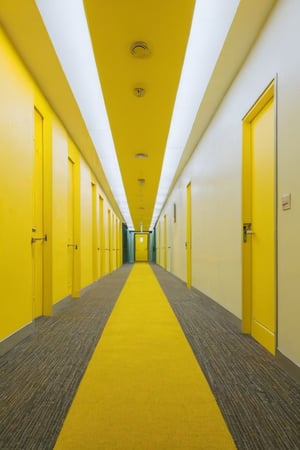 Endless yellow hallways, fluorescent lighting, moist carpet, liminal space, eerie atmosphere, hyper-realistic, 8k resolution, wide-angle lens



