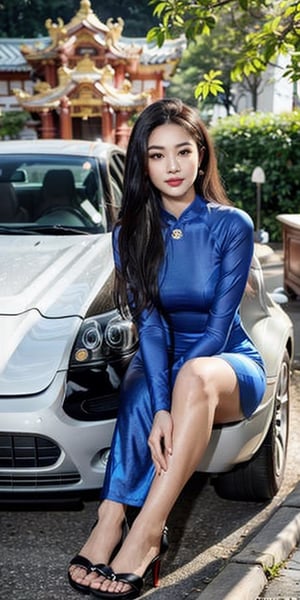 A beautiful Vietnamese girl wearing a traditional ao dai with a family crest for the Lunar New Year, holding a lotus flower, sits in a temple and lights incense in front of a Buddha statue, wishing him peace. Her husband in tuxedo with luxury watch and car stand behind her. 