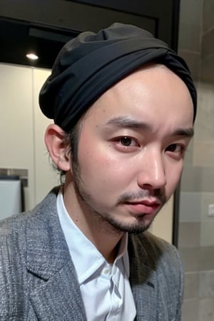 1boy, solo, brown eyes, lips, portrait,  wide forehead, rnhg , A man wearing a headscarf, minimalist, monochrome, clean lines, tailored suit, sleek, elegant, silver watch, urban setting, sophisticated, refined, professional