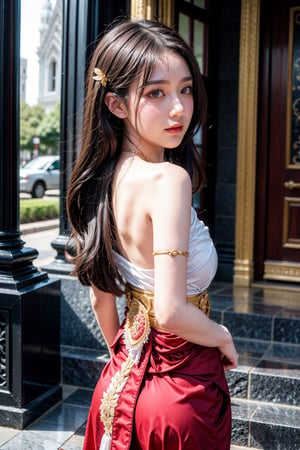 A half-body shot of a beautiful Thai girl standing gracefully in front of a traditional Thai temple at dusk. She wears an exquisite, intricate Thai dress (chut Thai) made of rich silk in a deep gold and crimson color. The top portion of her dress is wrapped in a delicate silk shawl, draped over one shoulder, adorned with traditional gold embroidery and subtle patterns. Her long, dark hair is neatly styled, cascading down her back, with a gold hairpiece delicately holding part of it in place. Her face exudes calm elegance, with a serene expression that matches the tranquil atmosphere of the evening. The temple behind her, with its ornate carvings and golden accents, glows softly in the fading light of the sunset, enhancing the rich cultural beauty of the scene.