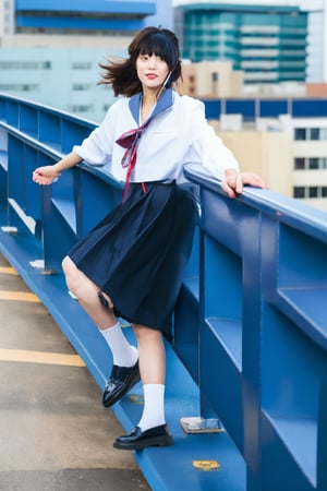A young Asian woman with short hair, wearing a colorful and eclectic outfit with blue as the dominant color. She is posing confidently on a rooftop, with a slight lean and one foot propped against a railing. The background features urban buildings under a cloudy sky, creating a modern and edgy atmosphere. The woman's outfit includes unique elements such as fluffy blue shoes and layered accessories, emphasizing a futuristic and fashionable style