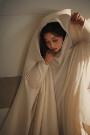 asian bride's eyes buried  disolving shrinking underneath a falling white flowing cloak that is covering her face, surrounded by a pooled fallen large flowing white crumpled gown on the floor melting