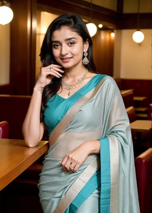 Lovely cute hot Alia Bhatt, acute an Instagram model 22 years old, full-length, long blonde_hair, black hair, They are wearing a light blue and green Floral Woven Design Saree. The background cafe drinking water. indian cafe, necklace on sarees, photo pose smile, 