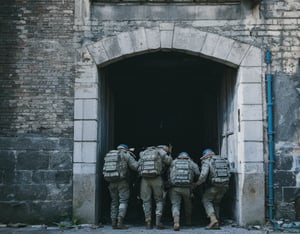 A prompt for a war-themed image!

Here's the generated prompt:

A scene of 4 soldiers in a moment of gunfire. The soldiers wear black armor with icy cold masks adorned with iron engravings, their faces set in determination. One soldier crouches behind cover, another peers around a corner, while two more take aim, ready to fire.

The setting is a ruined city gate, the once-majestic entrance now battered and worn. The lighting comes from above, casting a soft, diffuse glow over the scene. The main light source is positioned off-center, creating a sense of tension and uncertainty. The fill light softens the shadows cast by the soldiers' silhouettes, while the back light separates the subjects from the background, adding depth to the composition.

The color palette is monochromatic, with shades of gray and blue dominating the scene.