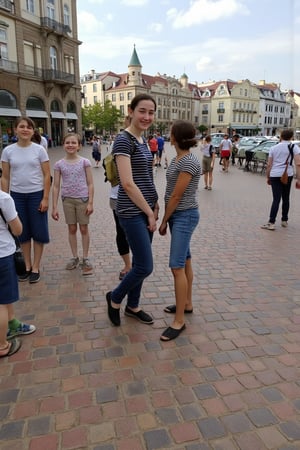 Photograph of a young woman pn holiday in a famour tourist destination, smiling. 