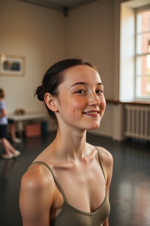 A close-up shot of a 50-year-old ballerina beaming with joy, her tall and slender figure illuminated by soft, warm lighting. Wrinkles on her pale skin radiate from the corners of her eyes and mouth, giving away her age. Her black hair is styled in a sleek bun, revealing scattered freckles across her cheeks. MsLauren's gentle smile hints at a lifetime of dedication to her craft, as she stands poised, one leg slightly bent in a subtle ballet pose, surrounded by the quiet elegance of a minimalist studio setting.