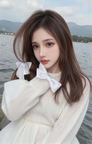 A woman is standing on the riverbank. She is wearing a white long sleeved dress and a white bow, Her hair draped over her shoulders, adding a touch of dynamism to her face. The sky is a soft blue with a few thin clouds that add depth to the scene. The woman's gaze turned towards the audience. The background is a peaceful lake, with rocks and mountains in the distance.long brown,Double upper eyelids,eye bag,half open eyes,shy,