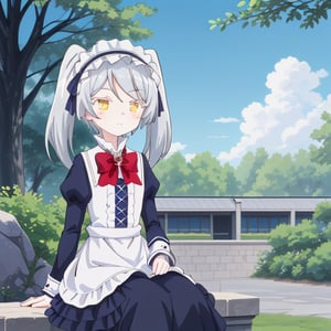 The image features an anime-style character sitting outdoors on a stone bench or ledge. The character is a young girl with long, silver-gray hair styled in twin tails. She is dressed in a classic maid outfit that includes a black dress with white accents, a white apron, and a frilly headpiece. The dress is adorned with a large red bow and a gemstone brooch at the collar. The character has golden eyes and a gentle, friendly expression with a slight blush on her cheeks. The background shows a sunny day with a well-maintained park, green bushes, and trees, as well as some parked cars and a clear blue sky with soft clouds.