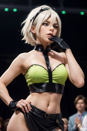 female character. She has short, straight white hair with darker roots, and her bangs fall just above her bright green eyes. She's wearing a sheer, off-the-shoulder green top with a black undergarment that emphasizes her figure. Her left hand is raised to her mouth, with a black fingerless glove on, and she appears to be lost in thought or teasingly biting her glove. She has a black skirt on, which sits on her hips, revealing a sliver of her midriff. The background suggests an indoor setting