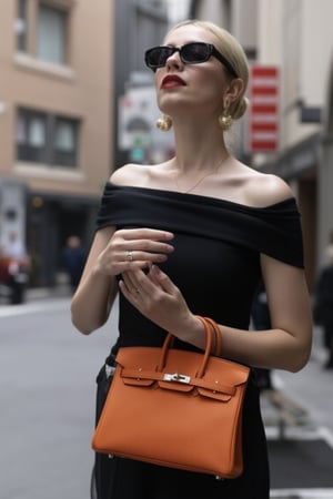 A stylish Italian influencer, 30 years young and radiant, holds her prized orange Togo leather Birkin 25 bag. She is walking in Duomo square in Milan, with a black elegant and sofisticated dress.