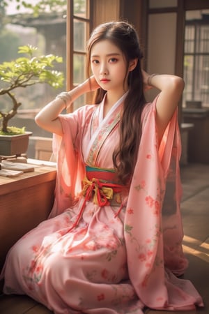 Realistic portrait photography, playing Yadouzi from Demon Slayer: Kimetsu no Yaiba. The picture shows a young Korean woman with long brown hair, wearing a pink floral patterned yukata and a colorful sash, kneeling on the wooden floor by the window. She put her hands behind her head in a casual and candid pose. Bright sunlight pours in, casting a warm glow on her and the wooden interior. The backdrop includes a bonsai landscape and traditional Japanese architecture, showcasing a tranquil cultural environment. The overall composition is balanced, blending traditional clothing with a modern and relaxed atmosphere.