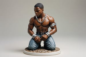 A full-color, delicately painted porcelain figurine depicting a kneeling, muscular 20-year-old black man in a leather harness and handcuffs and hands over head.The figurine is 6 inches high, barefoot, and exudes confidence and athleticism, with intricately detailed and perfect hands. It's displayed on a small white stand, placed on a coffee table in a party setting.