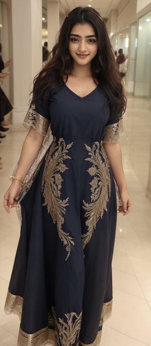 A stunning Pakistan teenage girl, only 18 years young and already a confident Instagram model. She's dressed to impress in a navy blue faux georgette gown with metallic foil and embroidery, her beautiful hair styled in vibrant, colorful Hollywood waves. With a radiant smile, she confidently walks towards the camera, as if sashaying down the catwalk of my shopping mall, her eyes sparkling with excitement.