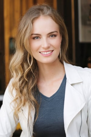 Hyperrealistic full body raw photo of Angelica, realistic face, realistic eyes, wearing dark wash skinny jeans, a white cotton t-shirt with a subtle detail, and a brown leather jacket. She is in a charming cafe, with a steaming cappuccino in her hands, smiling slightly as she observes the busy street. Cinematic style with soft, natural lighting, and muted, film-like colors.