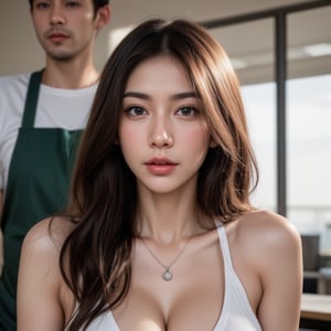 a close-up shot of a young Asian woman with long, wavy brown hair and dark eyes, is positioned in a seductive pose. She is wearing a silver necklace with a pendant, adorned with a silver charm, adding a touch of charm to her outfit. The backdrop is blurred, revealing a man in a white t-shirt and a green apron. The man's arm is positioned behind her, adding to the overall composition.