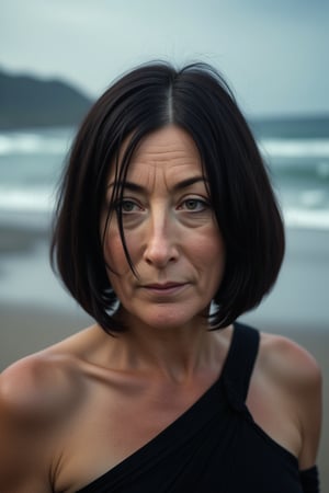 Hasselblad X2D 100C with polarizing filter, low exposure, high contrast, ISO 125, with a 50mm prime lens. Beautiful mature and slim woman, straight black hair in a short bob hairstyle, slight smile, dressed in sexy clothing, professional glamour photoshoot, background is a stormy Irish beach,