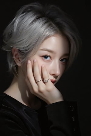 Asian portrait,A portrait of a person with short silver hair,partially illuminated by a narrow beam of light,wearing a black outfit,hand covers part of the face,showcasing minimalistic rings on fingers,makeup is subtle with attention on eyes and lips,expression appears contemplative,shadows enhance the dramatic effect,composition is intimate,color scheme relies on dark tones and highlights,the close-up angle emphasizes emotional depth,scene gives an artistic and moody vibe.