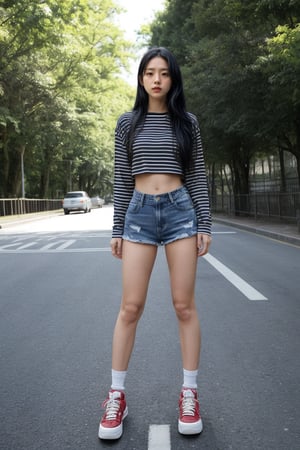 A girl, alone, with long black hair, wearing a long-sleeve striped shirt and denim shorts, the shirt slightly revealing her midriff. She has her eyes closed, wearing sneakers and knee pads, shown in full body. The scene is outdoors during the day, with a background of blue sky and trees. The girl is skateboarding on the road, with a street photo background