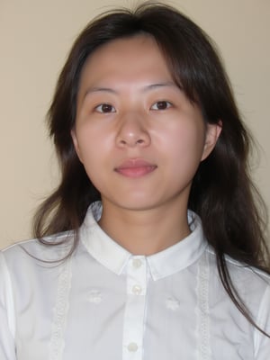 A close-up shot of a young Asian woman with long dark brown hair and brown eyes. She is wearing a white collared button down shirt with white embroidery on the collar. Her lips are a vibrant shade of pink. Her eyebrows are a light brown and her eyes are a darker shade of brown. She has a slight smile on her face. The backdrop is a light beige wall.