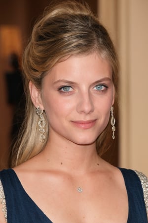 Melanie Laurent is at a gala ball, wearing a long dark blue silk dress with a V-neckline and a beaded embroidery. She wears a diamond necklace and long earrings with diamond details. She is wearing elegant makeup, with silver eyeshadow, black eyeliner, and a dark red lipstick. The image is in an elegant style, focusing on the dress, accessories, and pose of the actress. The lighting is soft, with warm tones, creating an atmosphere of luxury. The resolution of the image should be high, focusing on the sharpness and details of the clothing and accessories.