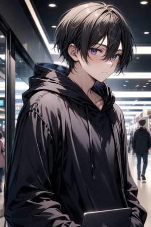 At the mall. Male hacker. black hair. black hooded shirt