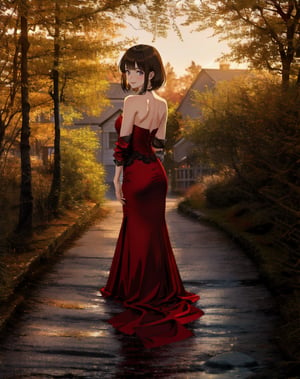 a beautiful young girl stands in a courtyard at dusk, with her hands behind her back. She wears a strapless maroon form-fitting satin evening gown, gazing upward wistfully.