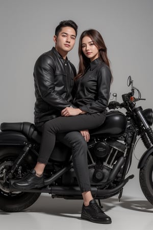 A couples wearing jacket and black jeans and leather shoes giving a pose to the camera and with the bullet bike