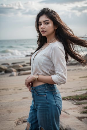 A stunning Indian woman, 26 years old, stands confidently on the sun-kissed beach, her long dark hair blowing gently in the sea breeze. She wears a pair of distressed blue jeans and a crisp white shirt, complementing her radiant complexion. A delicate necklace adorns her neck, and she gazes out at the endless ocean with a thoughtful expression. Her watch glints in the bright light as she takes in the serene atmosphere.