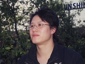 Floodlight,This is a sunlit portrait of a young boy in profile with he face to the camera,glasses,bathed in warm,soft light that creates a halo effect around he. He black hair . He is wearing sportswear, The background is blurred to ensure that the focus is on the subject. The photograph is softly lit and luminous,with delicate romantic tones and an ethereal,dreamy quality. The soft focus enhances the gentle and serene atmosphere of the image., where lush greenery and bold emblazoned words" SUNSHINE "create a striking visual counterpoint to her melancholic countenance, as if bathed in the faint light of the street lamps.(Film grain: 1.2, ultra detailed skin texture)