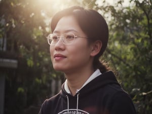 Floodlight,This is a sunlit portrait of a young boy in profile with he face to the camera,glasses,bathed in warm,soft light that creates a halo effect around he. He black hair . He is wearing sportswear, The background is blurred to ensure that the focus is on the subject. The photograph is softly lit and luminous,with delicate romantic tones and an ethereal,dreamy quality. The soft focus enhances the gentle and serene atmosphere of the image., where lush greenery and bold emblazoned words" SUNSHINE "create a striking visual counterpoint to her melancholic countenance, as if bathed in the faint light of the street lamps.(Film grain: 1.2, ultra detailed skin texture)